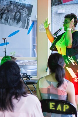 poet in concert lights speaking dramatically